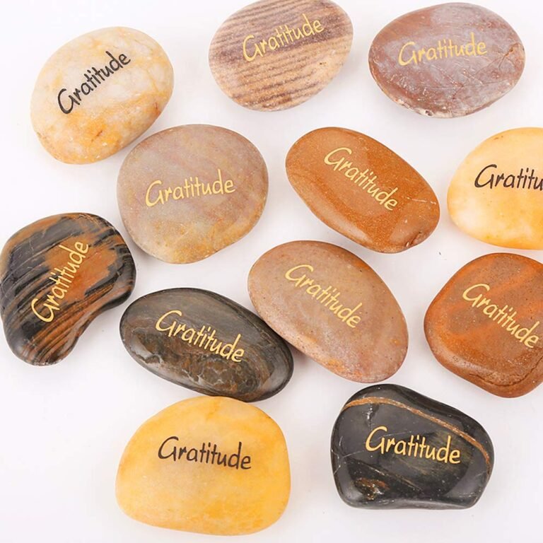 Various smooth stones with "Gratitude" written on them in gold