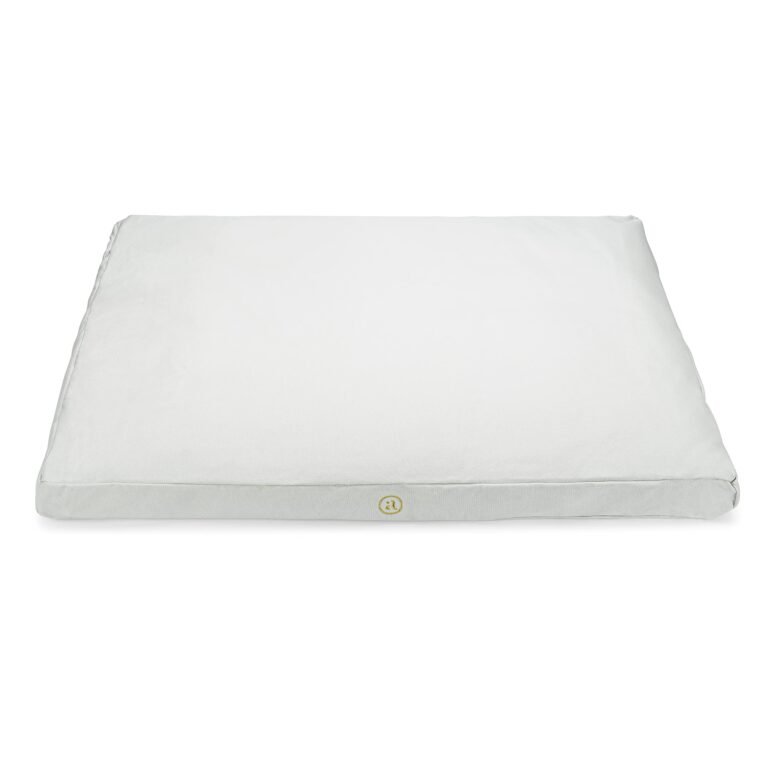 White rectangular dog bed with a gold logo on the front
