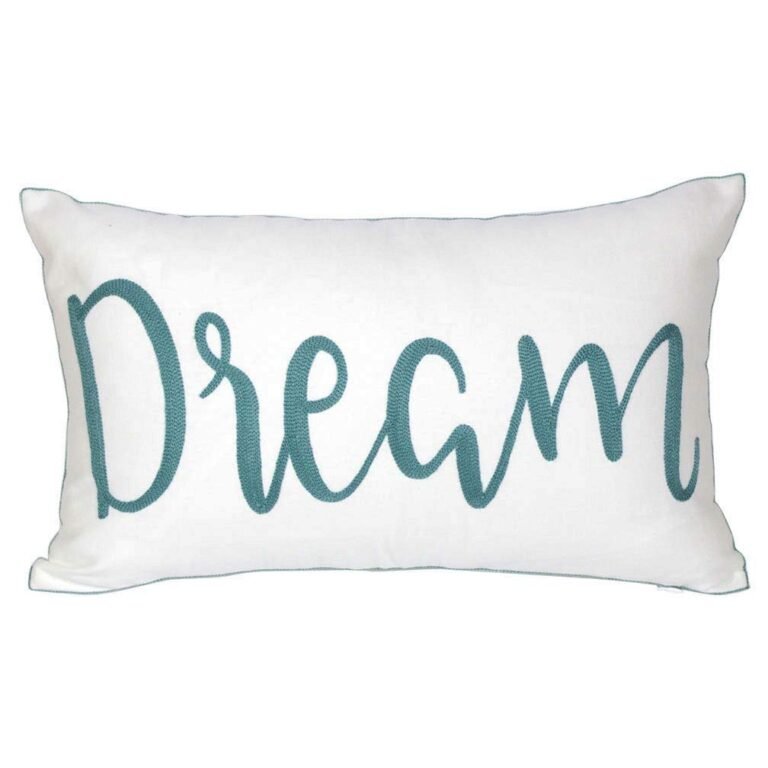 White pillow with teal "Dream" script and teal trim