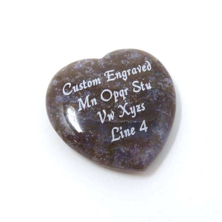 Heart-shaped stone with engraved text on a white background