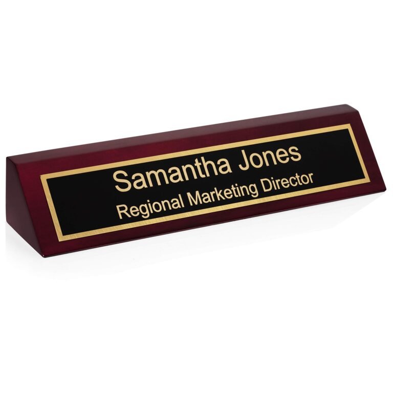 Desk nameplate with "Samantha Jones, Regional Marketing Director" on black and gold