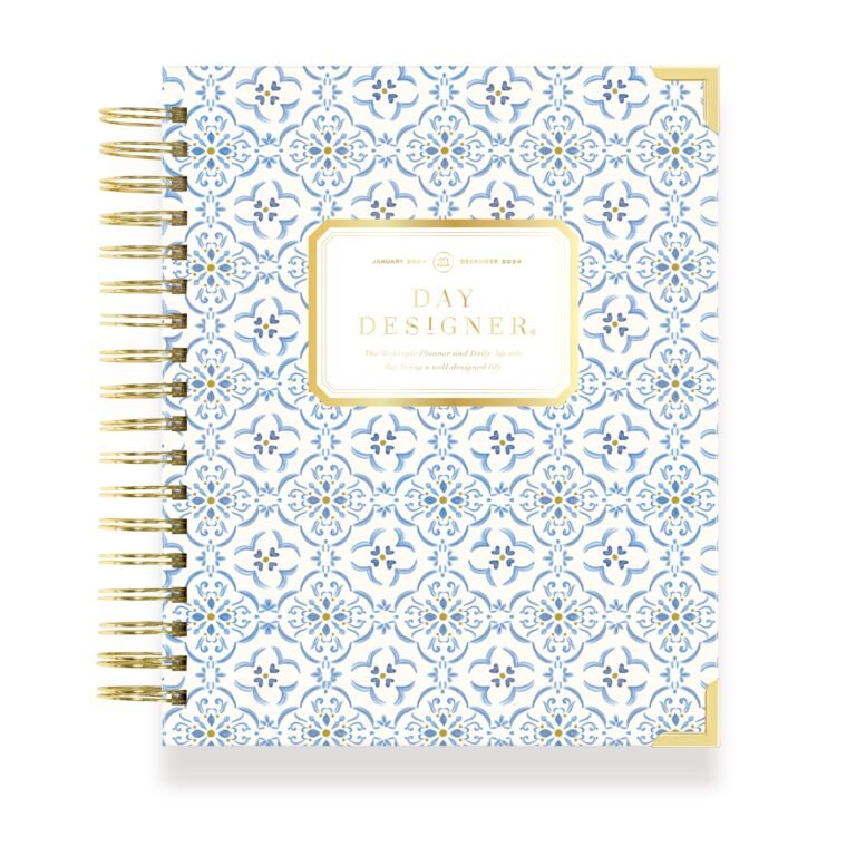 Blue and white patterned "Day Designer" planner with gold spiral binding and accents