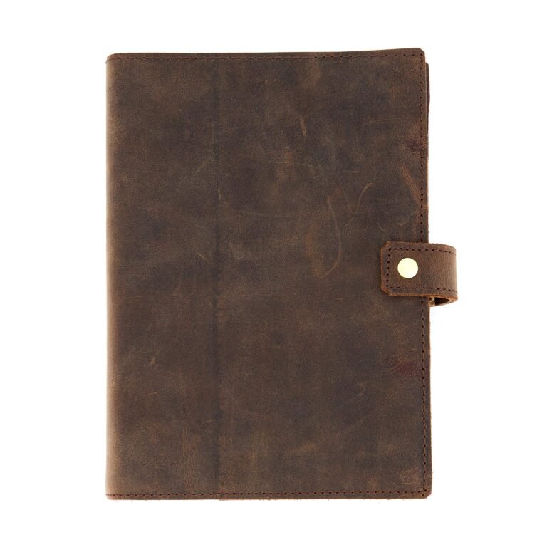 Brown leather journal with a snap closure on white background